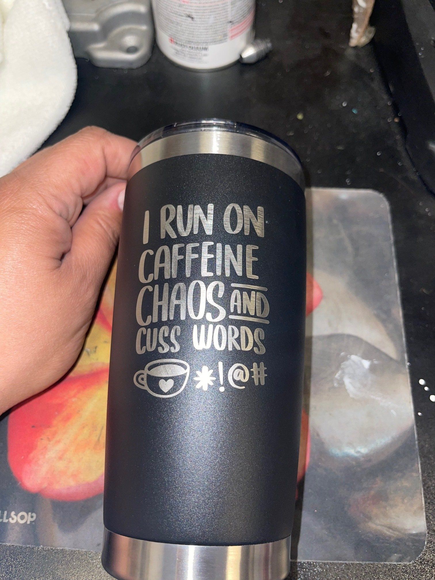 Black tumbler with white text reading, “I run on caffeine, chaos and cuss words.”