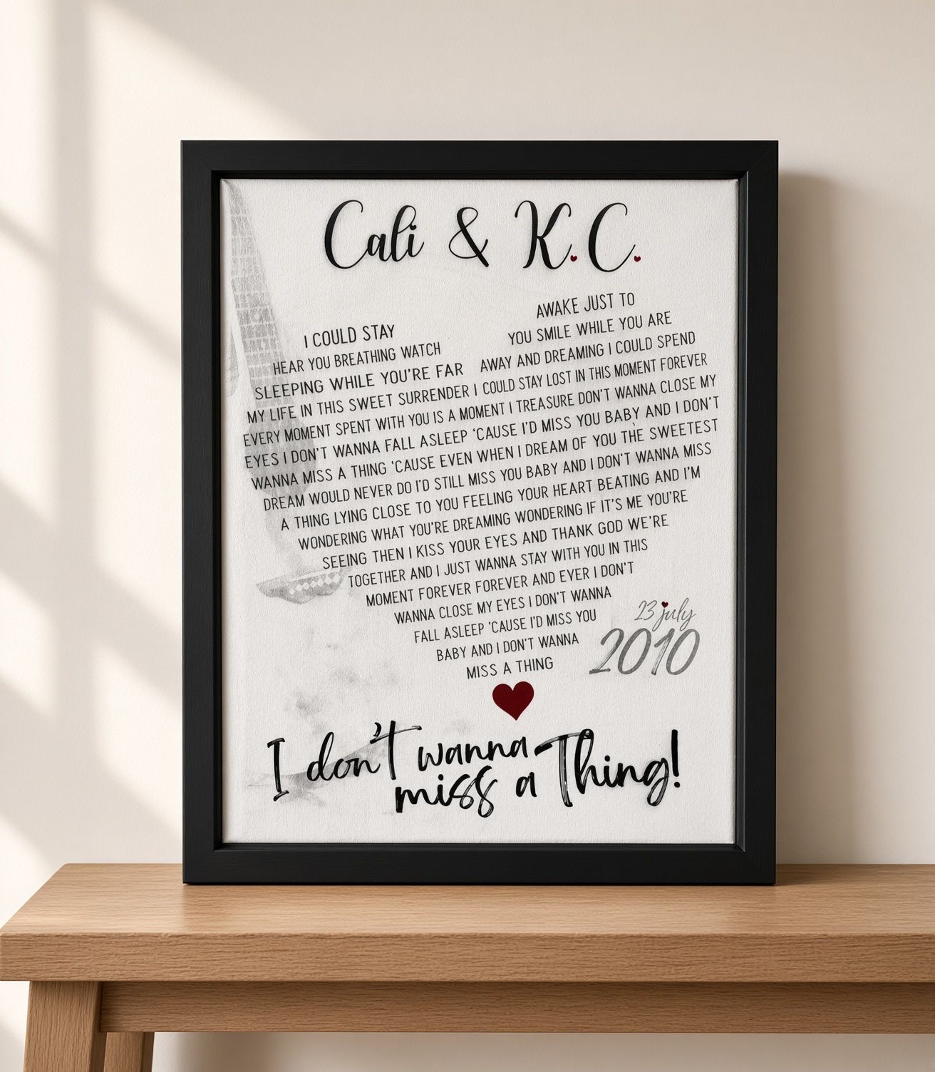 Framed “Cati & K.C.” keepsake with handwritten note, small heart, and “I don’t wanna miss a thing!” sign.