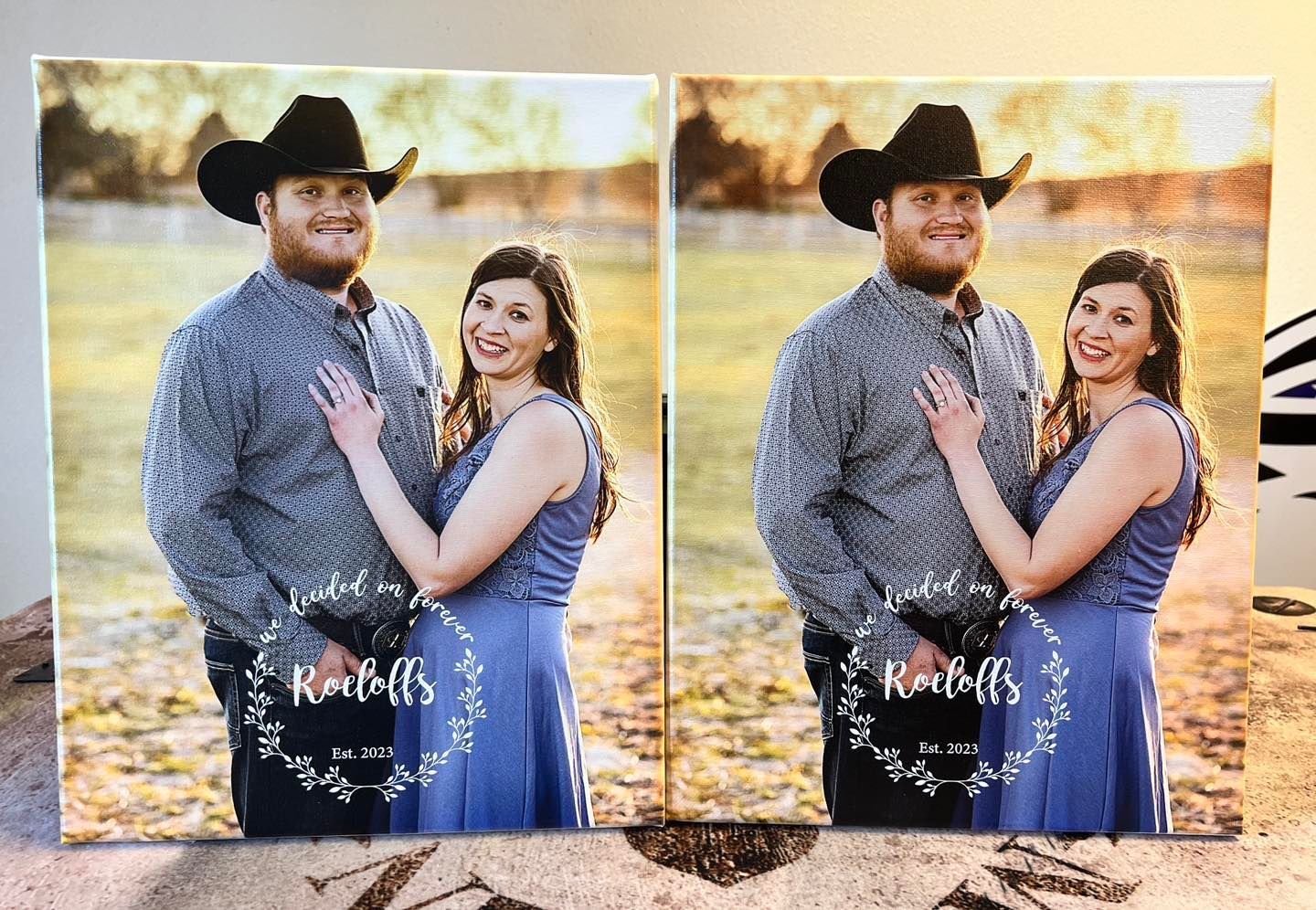 Two canvas prints of a couple embracing outdoors. They are smiling, he wears a cowboy hat. Wedding date and names in wreath.