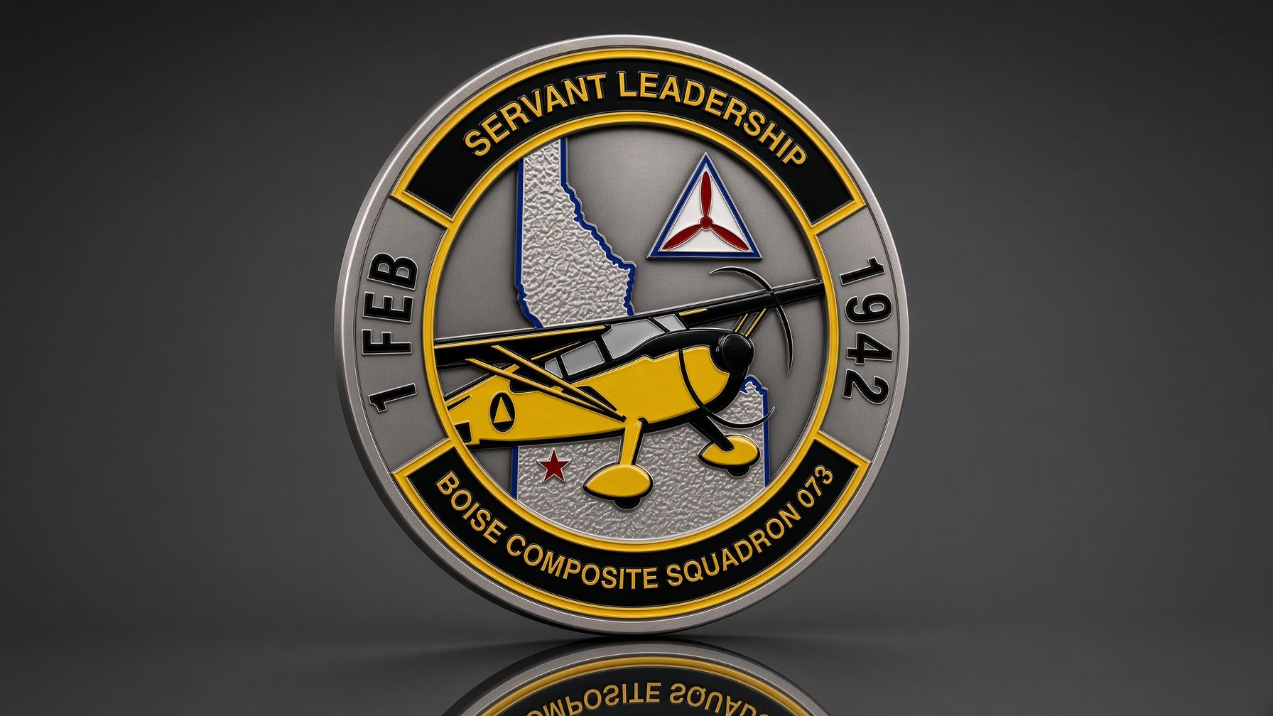Black-and-gold circular leadership badge with a yellow aircraft and triangle emblem on a gray background