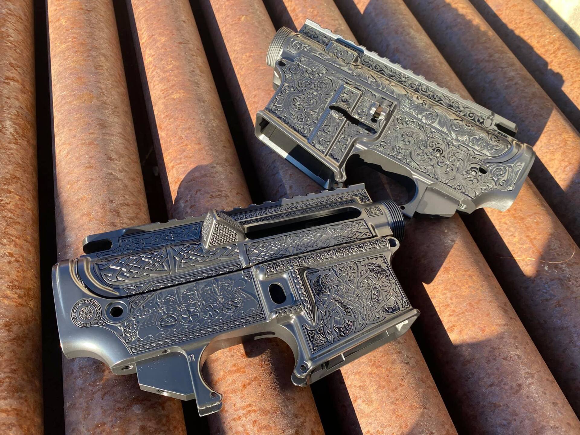 Two black pistols covered in water droplets resting on rusty corrugated metal sheets