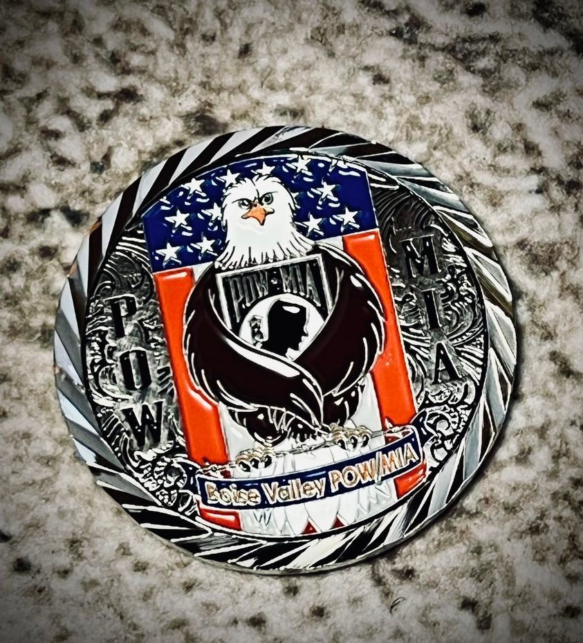 Coin with POW/MIA symbol, American flag, eagle, and text 