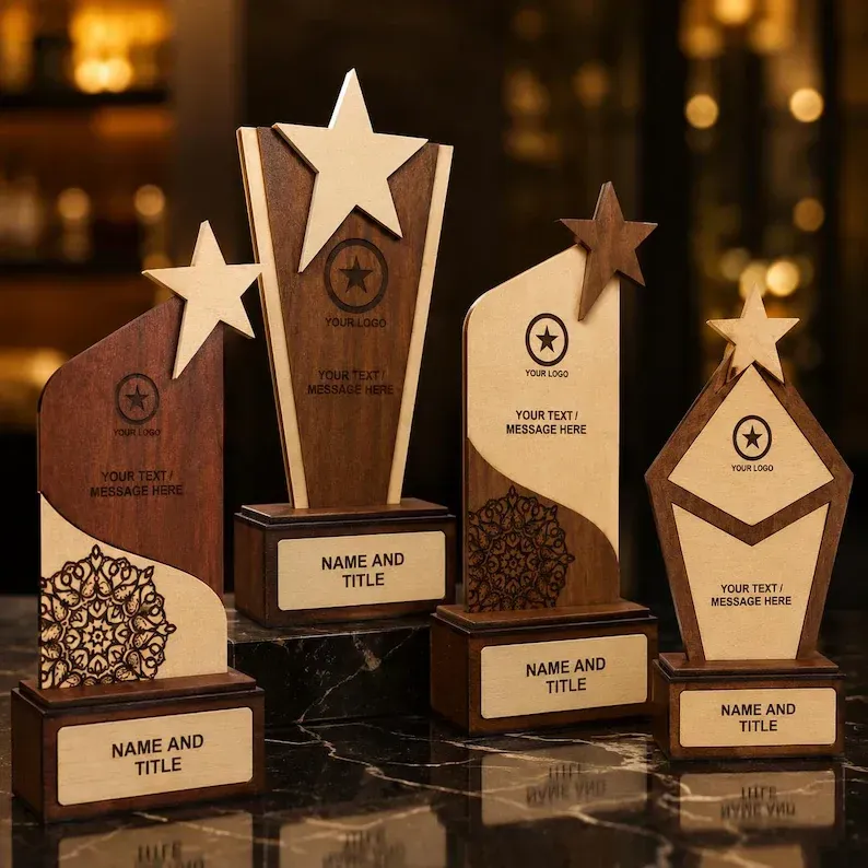 Assorted wooden award trophies with star tops on a table in warm, blurred indoor lighting