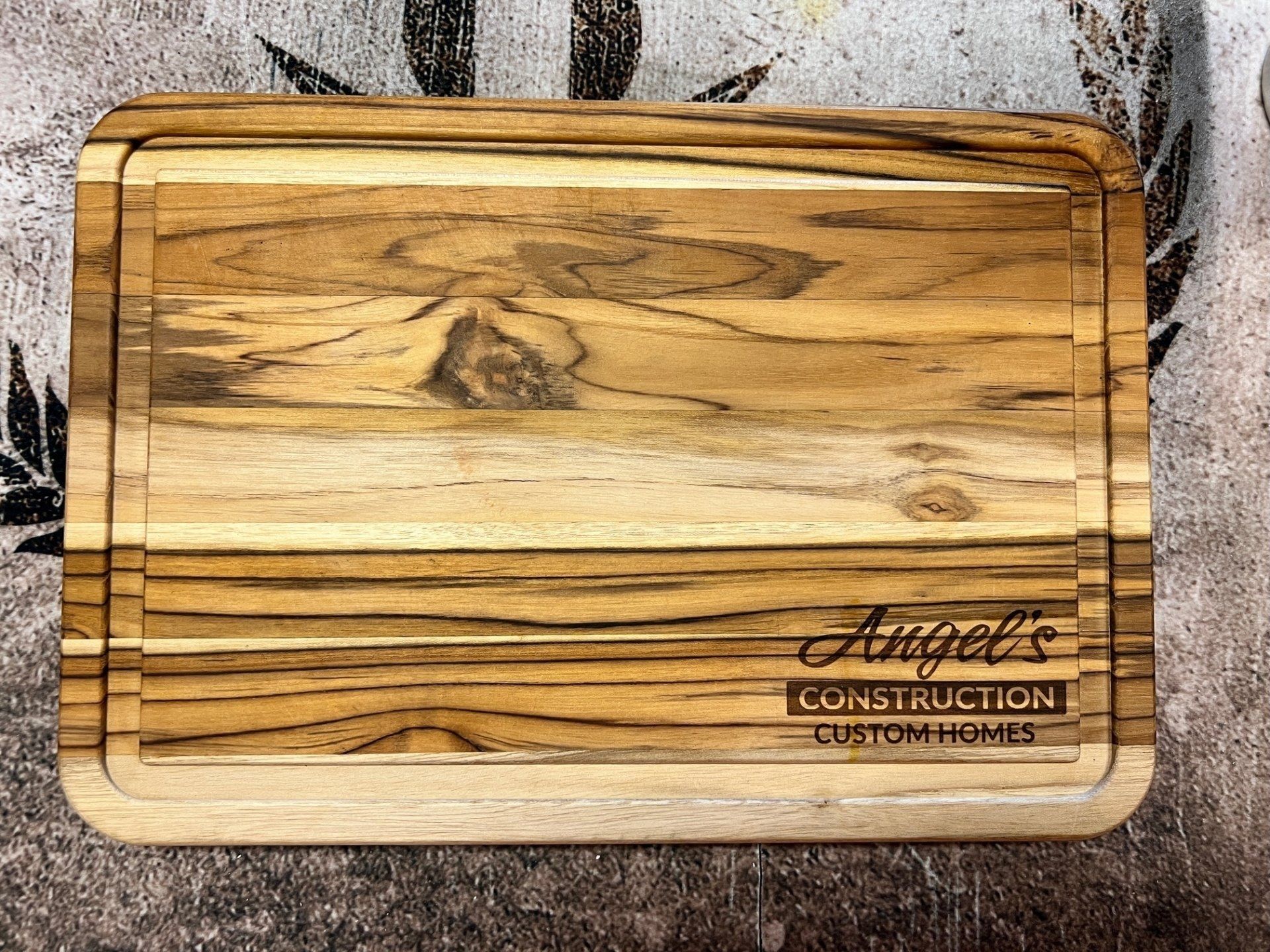 Wooden cutting board with etched business logo: 