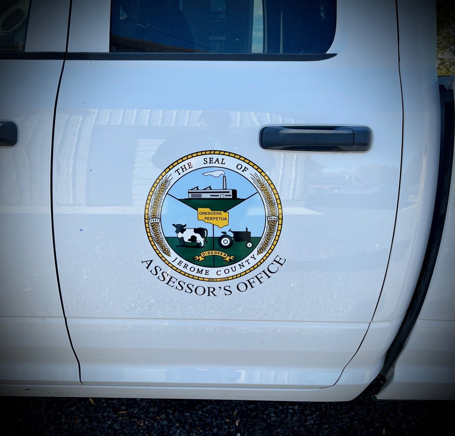 White truck door with the Irrum County Assessor's Office seal in a circular badge.