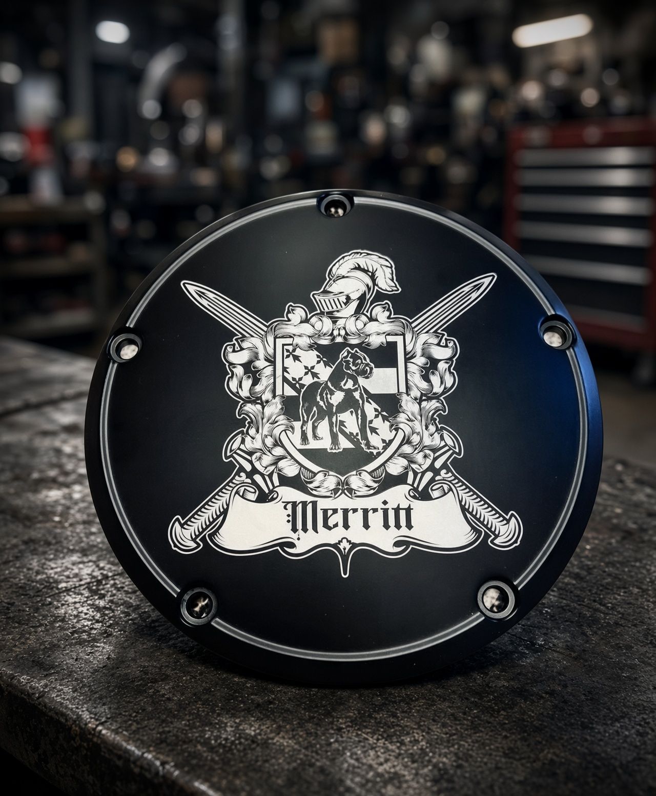 Black round shield with a white crest and the word “Merrit” on a textured wall background.