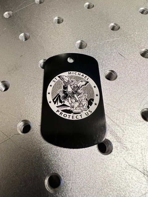 Black metal dog tag with laser-etched St. Michael image and 