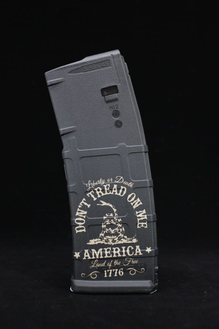 Black book-shaped object with “Don’t Tread on Me” and “Made in America” text on a dark background