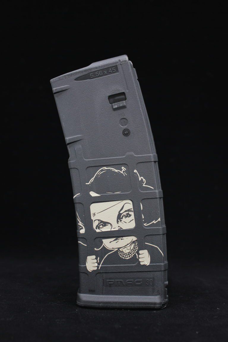 Black rectangular device standing upright on a dark background, with worn white graphics on the front.