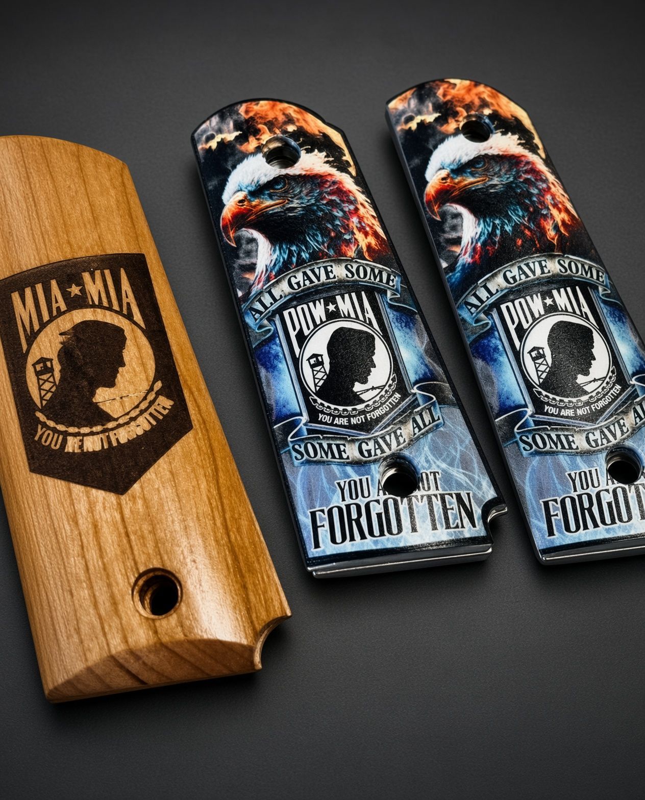Three skateboards with black-and-white graphic decks on a speckled floor beside a wooden plaque.