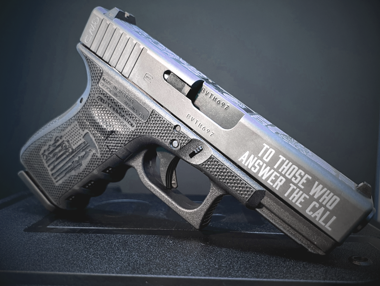 Gray handgun engraved with 