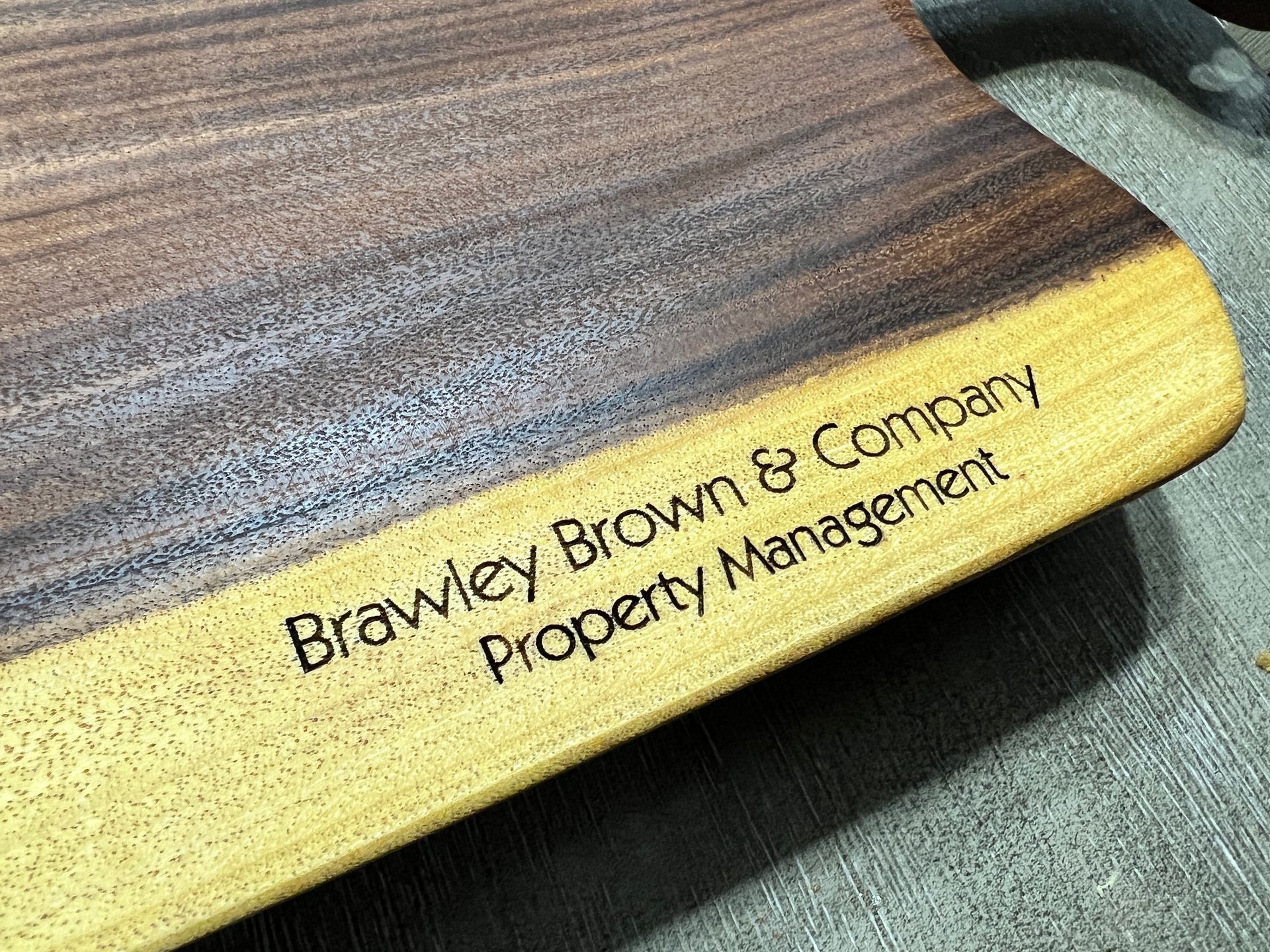 Brownway Brown & Company Property Management sign on a wood-grain surface