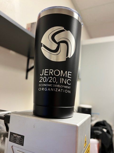 Black tumbler with silver logo and text, 