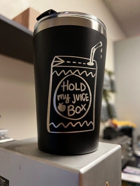 Black tumbler with etched juice box design and text: 