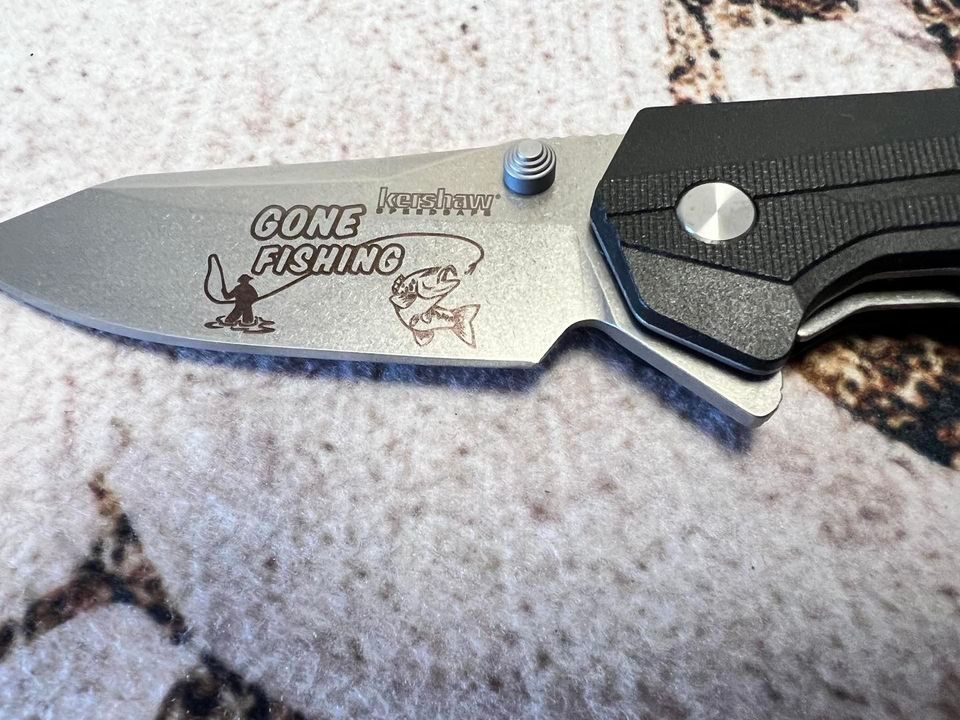 Folding knife with blade etched 