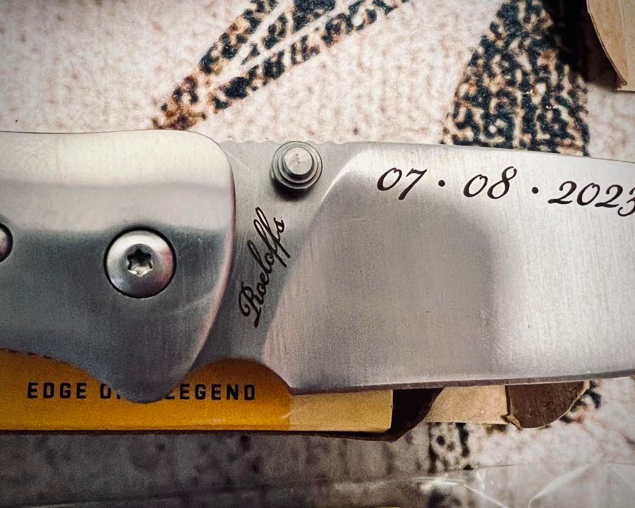 Close-up of a silver folding knife blade with 