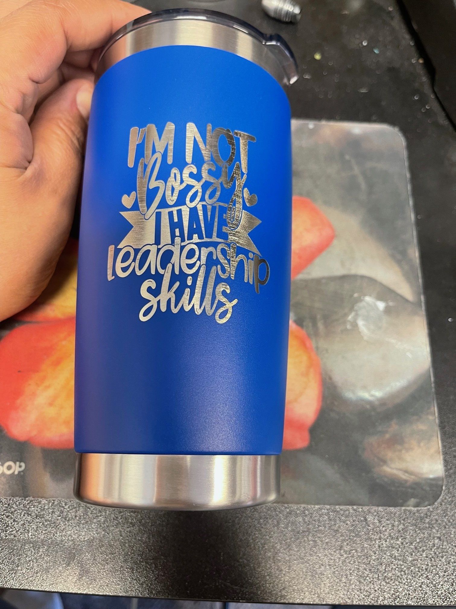 Blue tumbler with silver base and gold “I’m not bossy, I’m the leader” text on a countertop.
