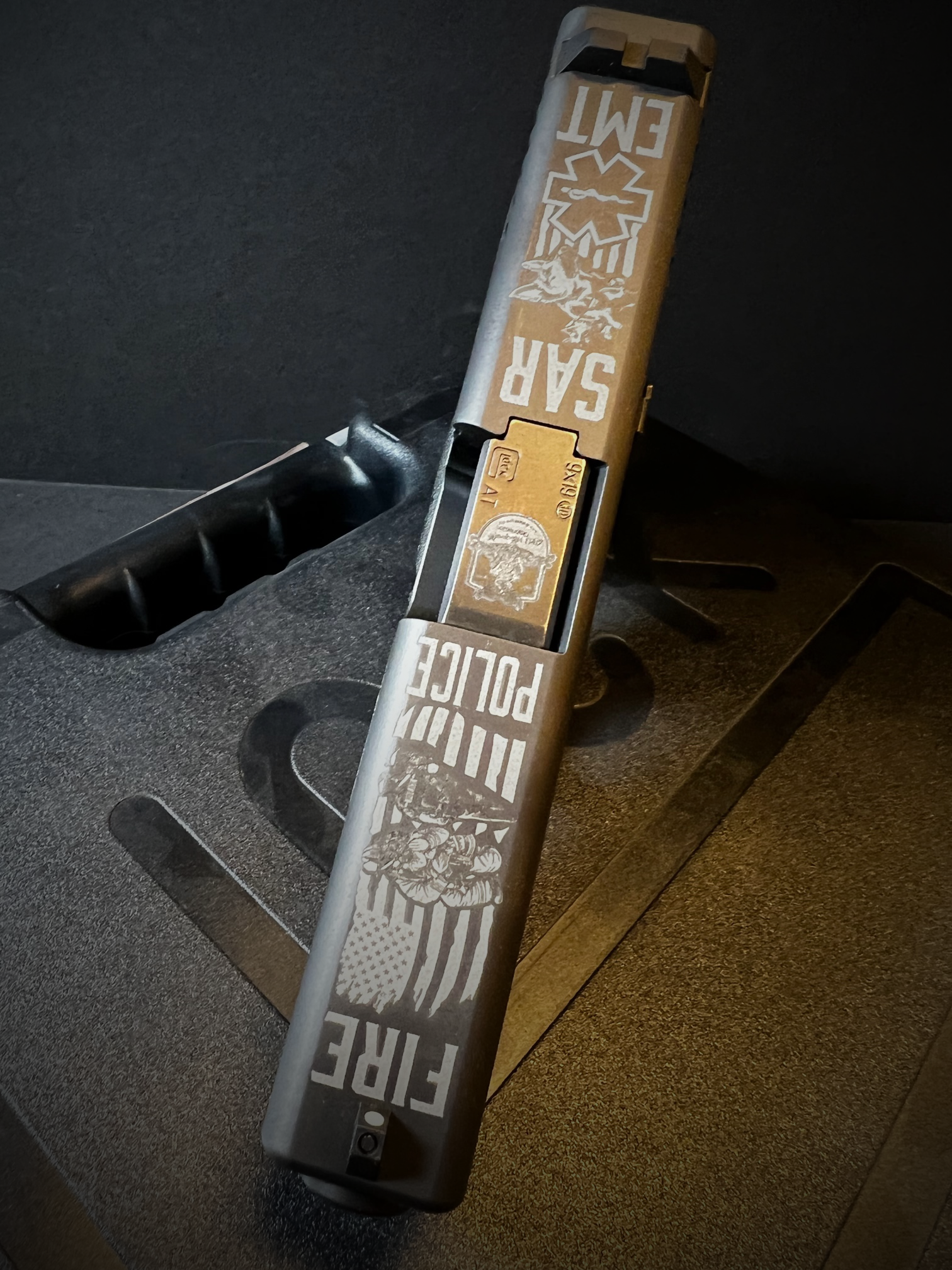 Close-up of a black and brown boxed item with white text, resting in a dark molded tray.