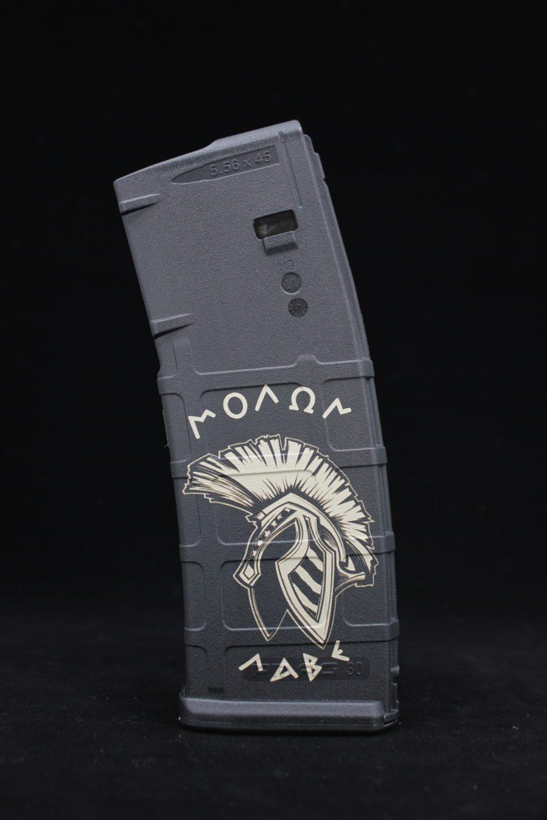Black magazine-style box with white tribal face illustration on a dark background