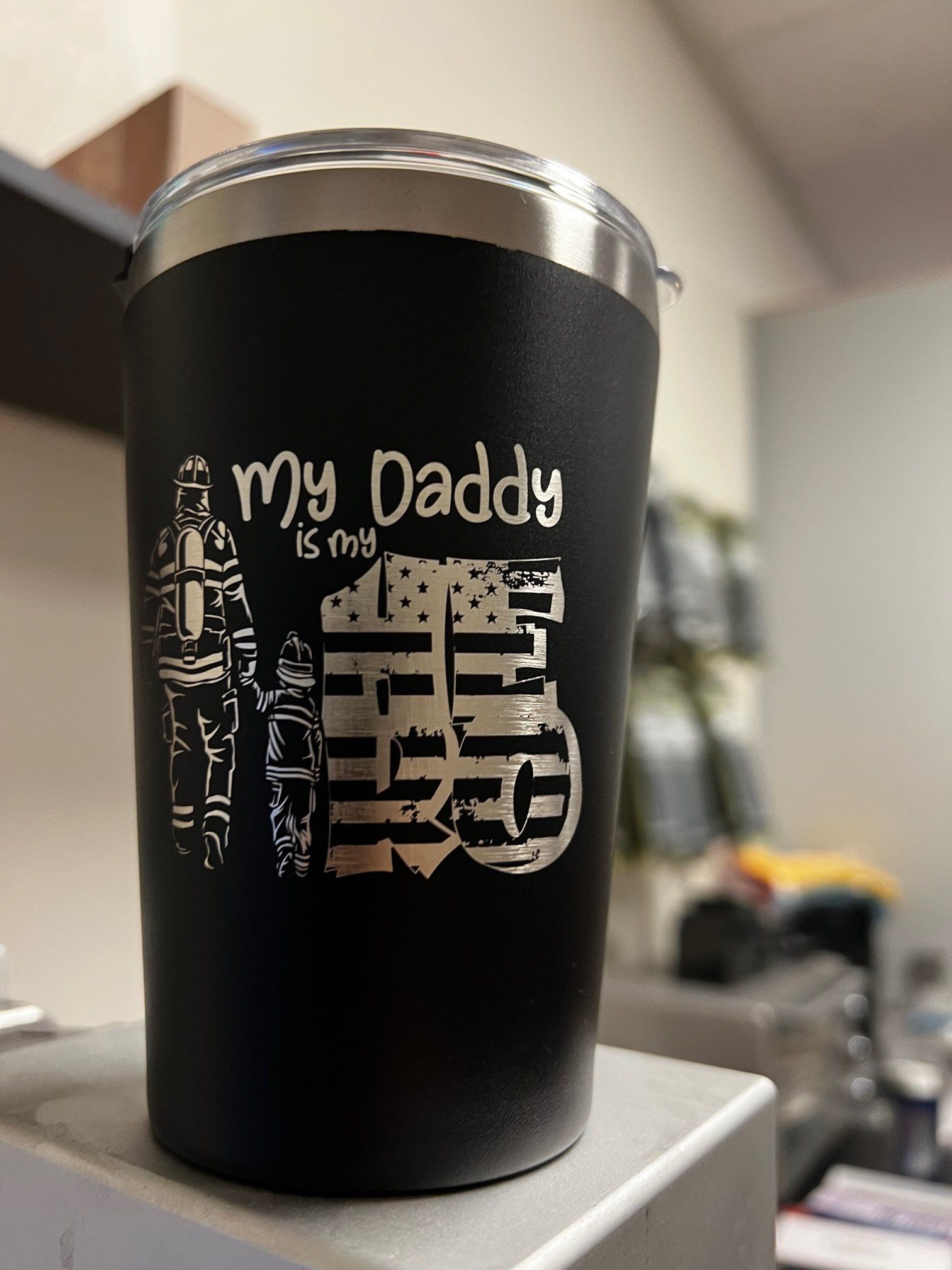 Black insulated tumbler with “my Daddy” and a large Chinese character, on a counter indoors