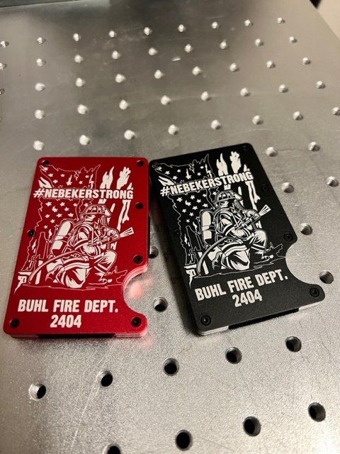 Red and black wallets with white etched designs, including text 