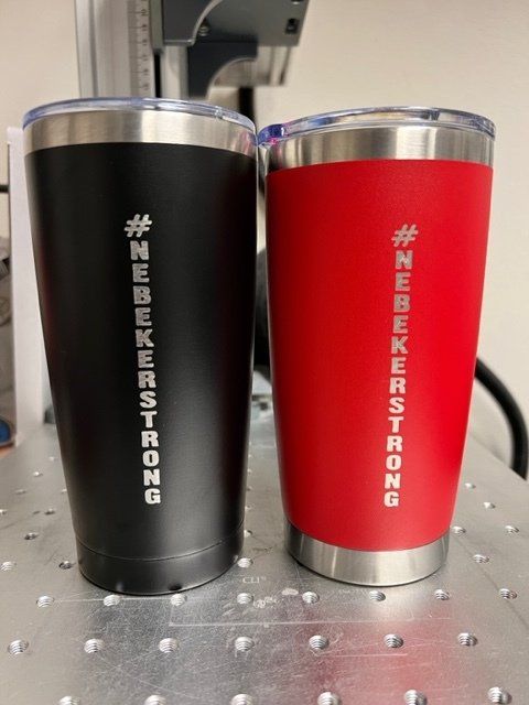 Two insulated tumblers: black and red, etched with 