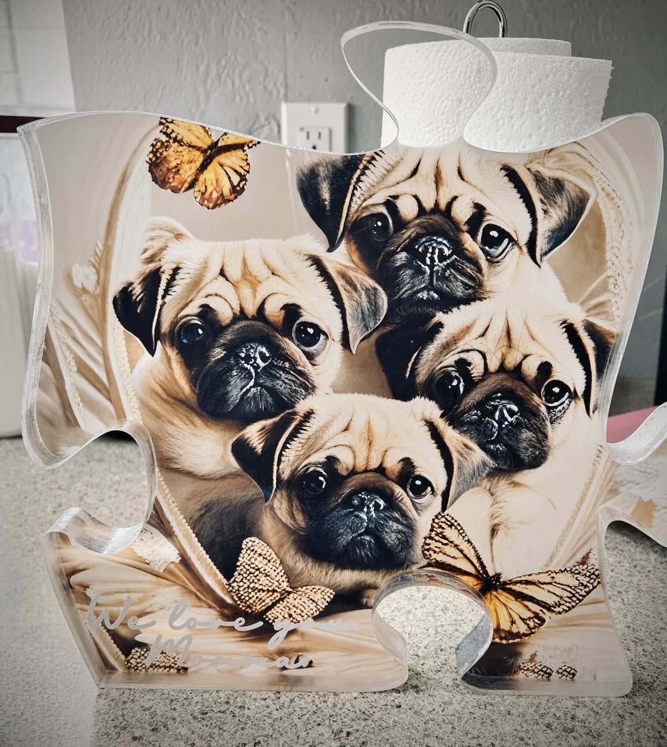 Decorative bag with four pug faces, butterflies, and a white bow on a gray background