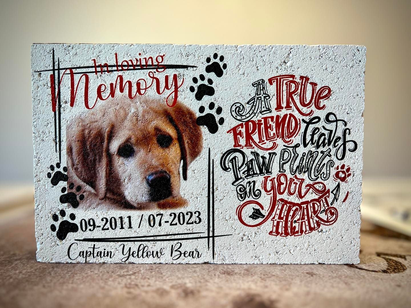 Memorial stone for a dog. Features a photo, text 