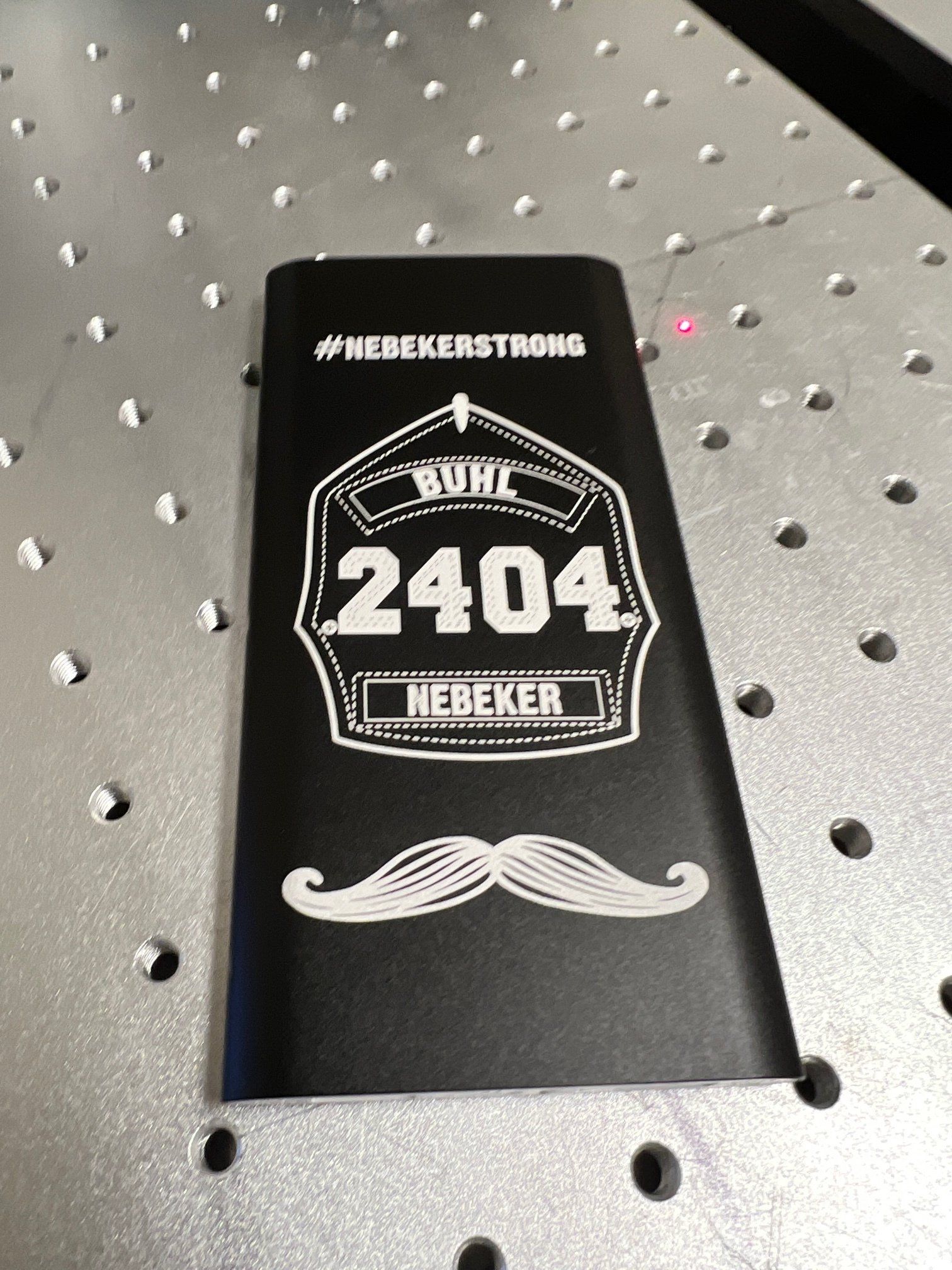 Black engraved power bank with fire helmet design, 