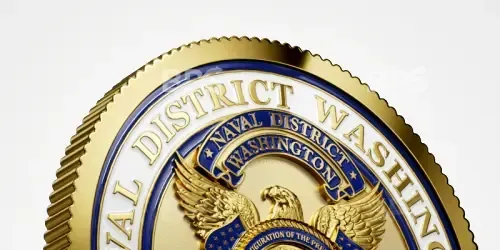 Close-up of a gold Washington, D.C. seal with a bald eagle and blue ribbon on white background