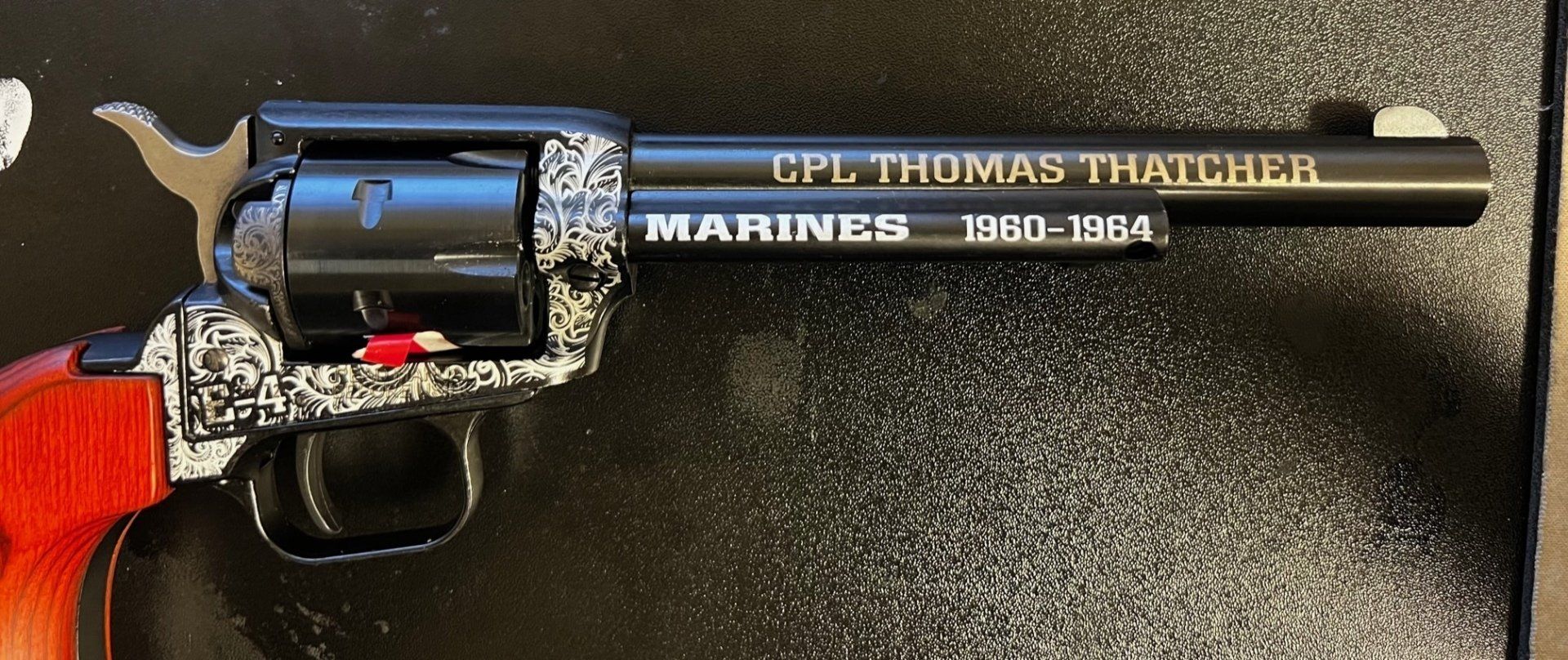 Black revolver with engraved detail. 