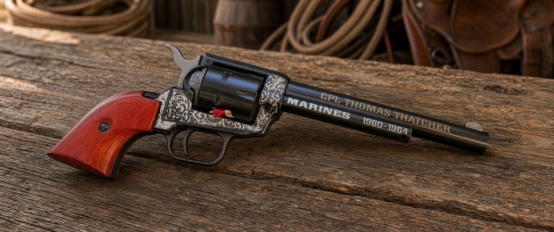 Toy revolver with black barrel and silver frame on a speckled surface, engraved with “MEL THOMAS THOMPSON.”