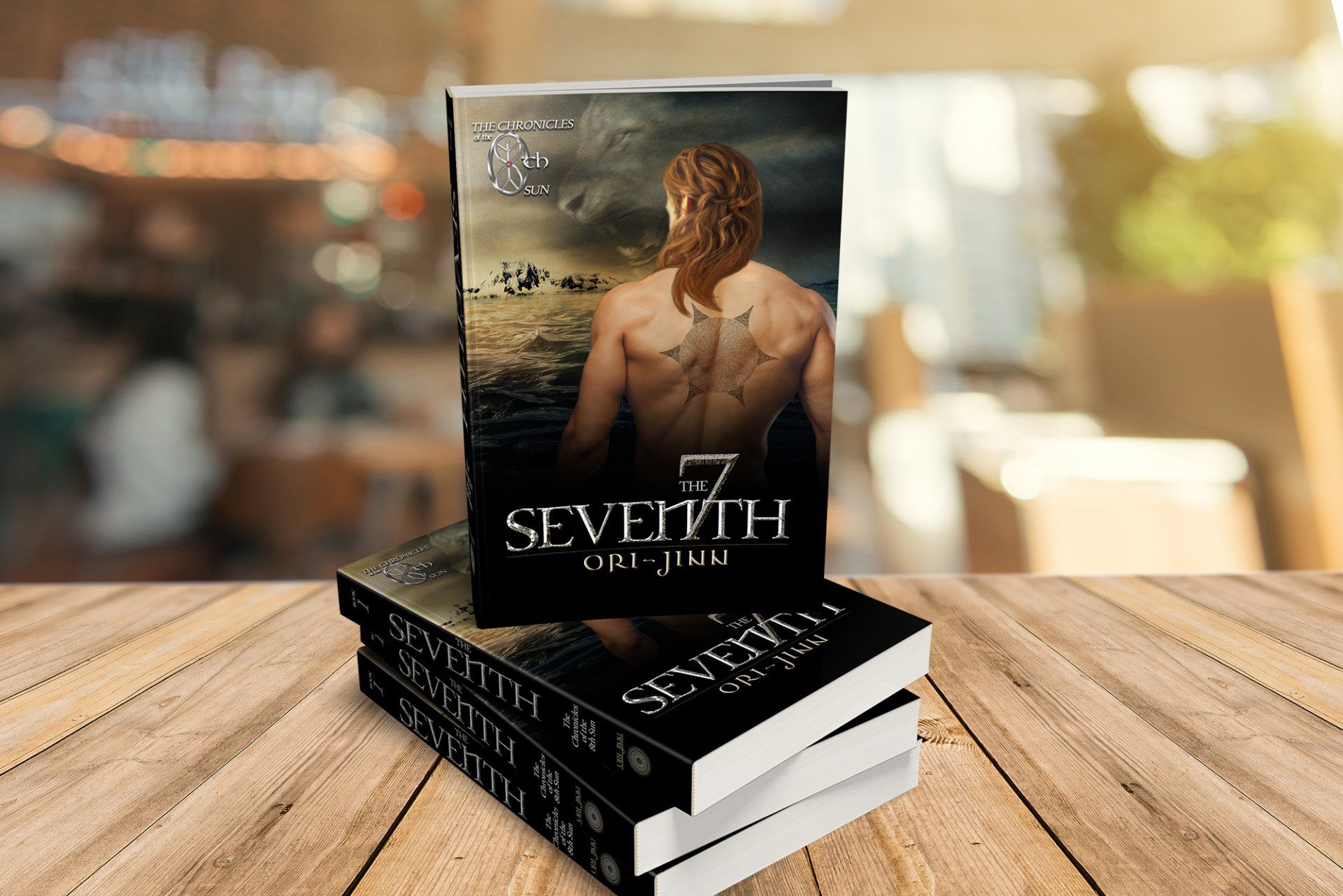 Books stacked on wood table; cover shows bare-chested person with tattoos standing in water.