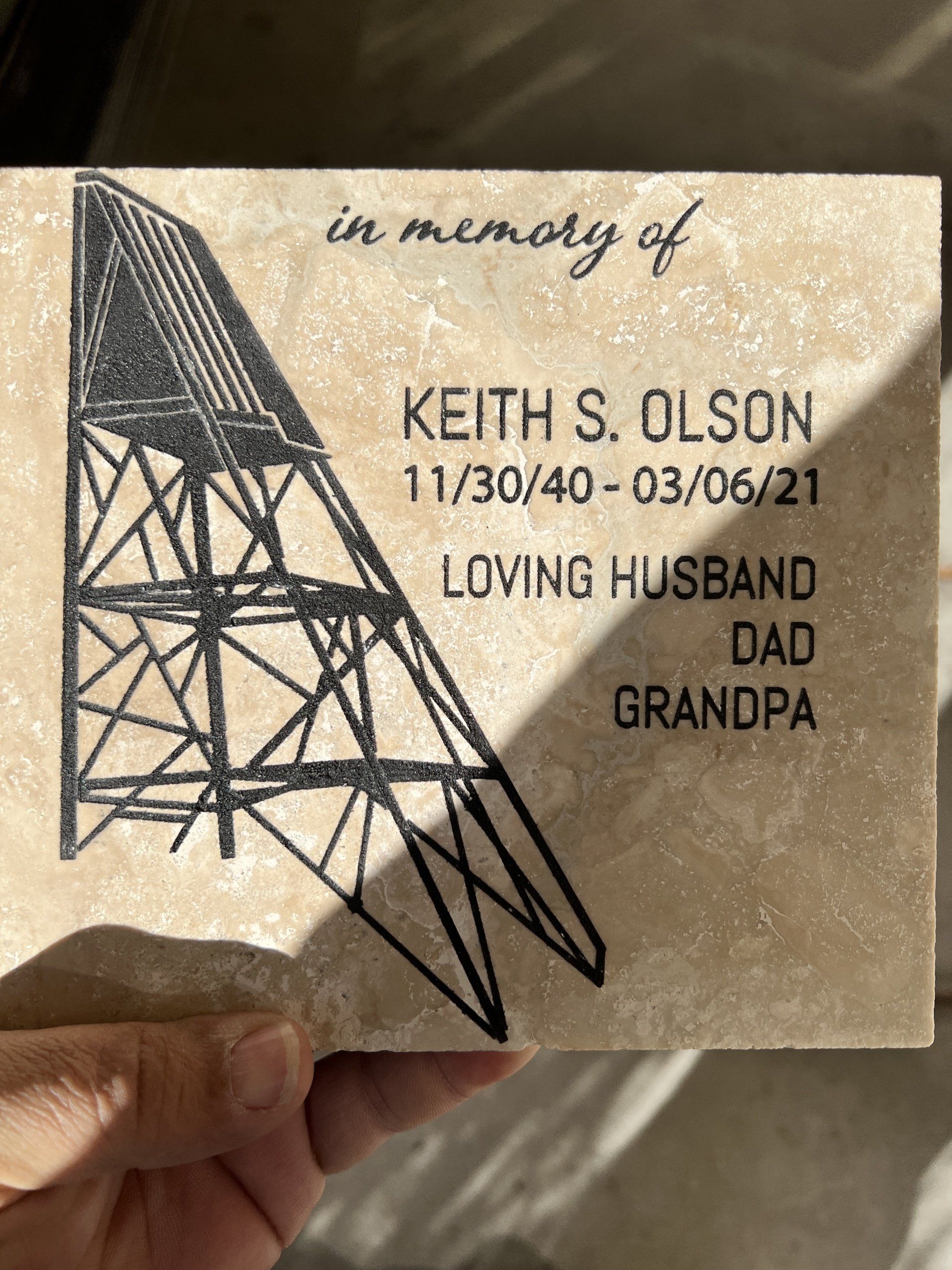 Memorial tile for Keith S. Olson, with his name, dates, and title, 