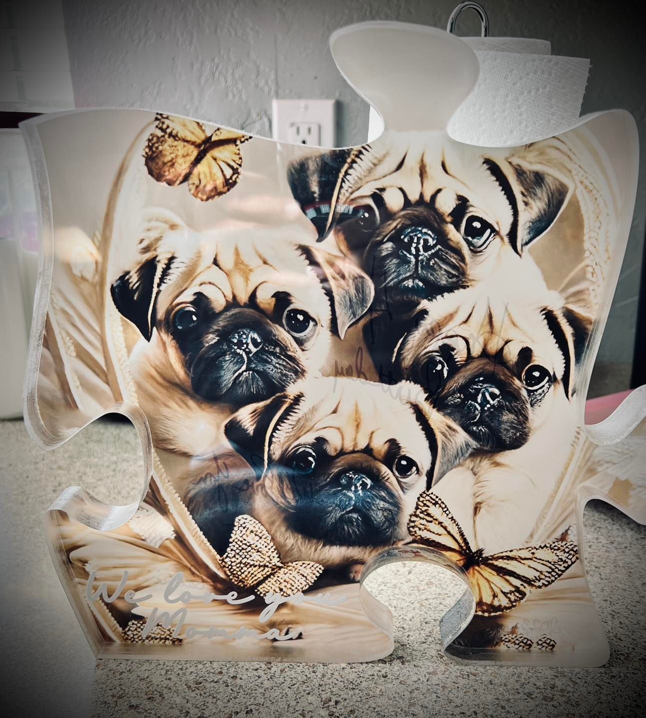 Pug puppies with butterflies, cream and brown, in a decorative artwork or pillow.