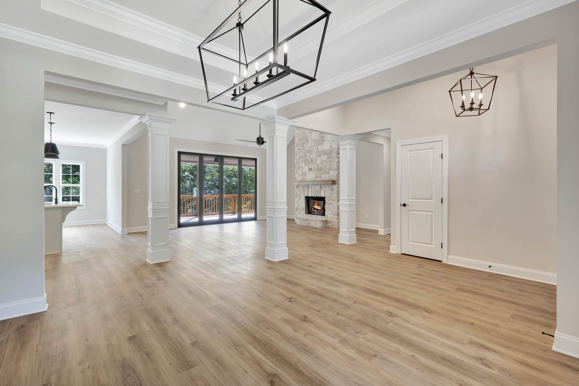 An empty living room with hardwood floors and a fireplace.