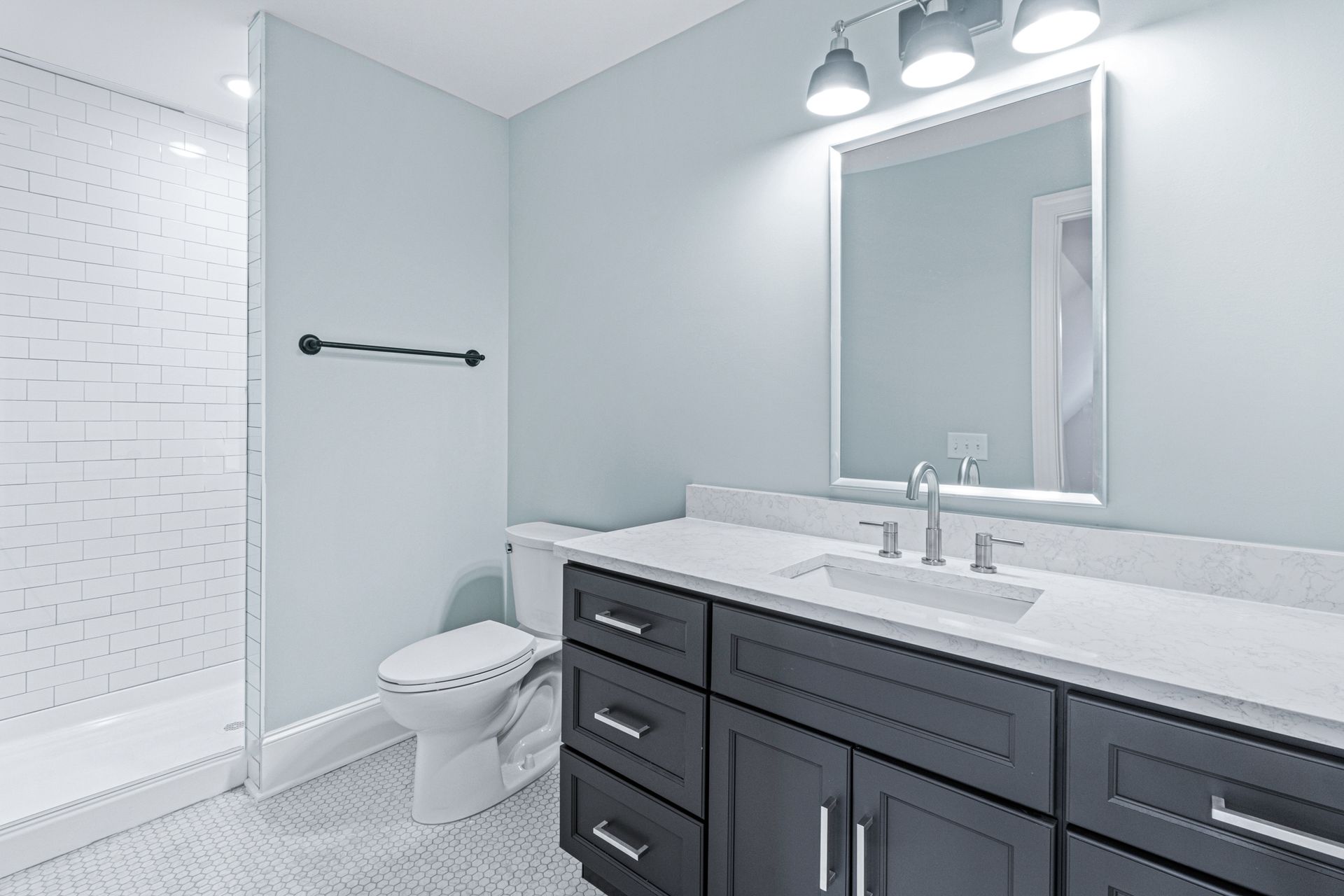a bathroom with a toilet , sink , and mirror .