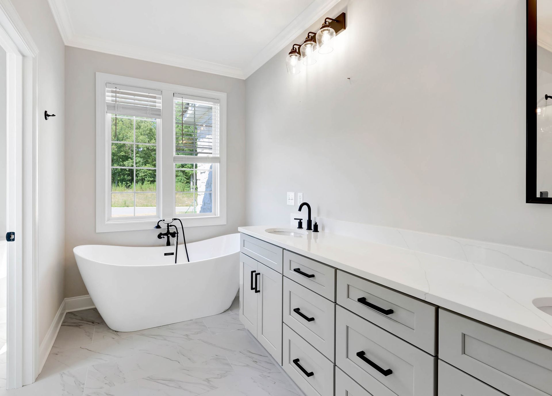 A bathroom with a bathtub , sink , and mirror.