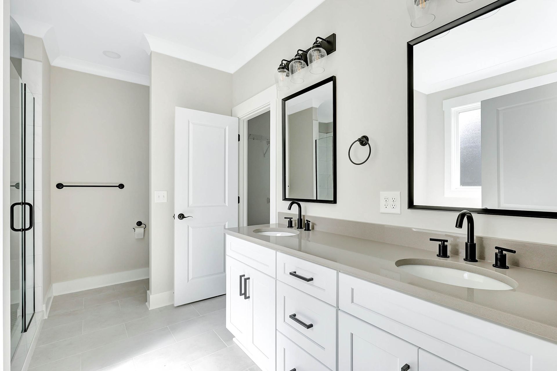 A bathroom with two sinks and two mirrors.