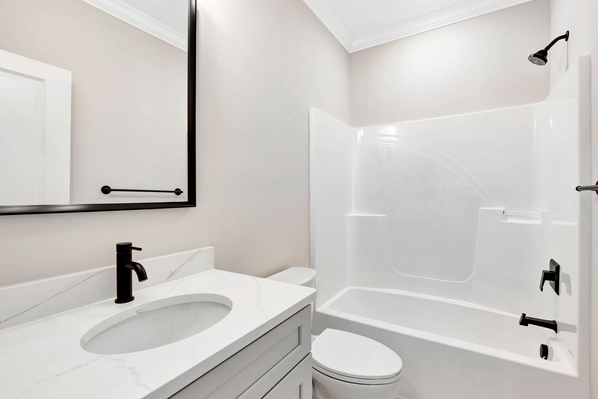 A bathroom with a sink , toilet , bathtub and mirror.
