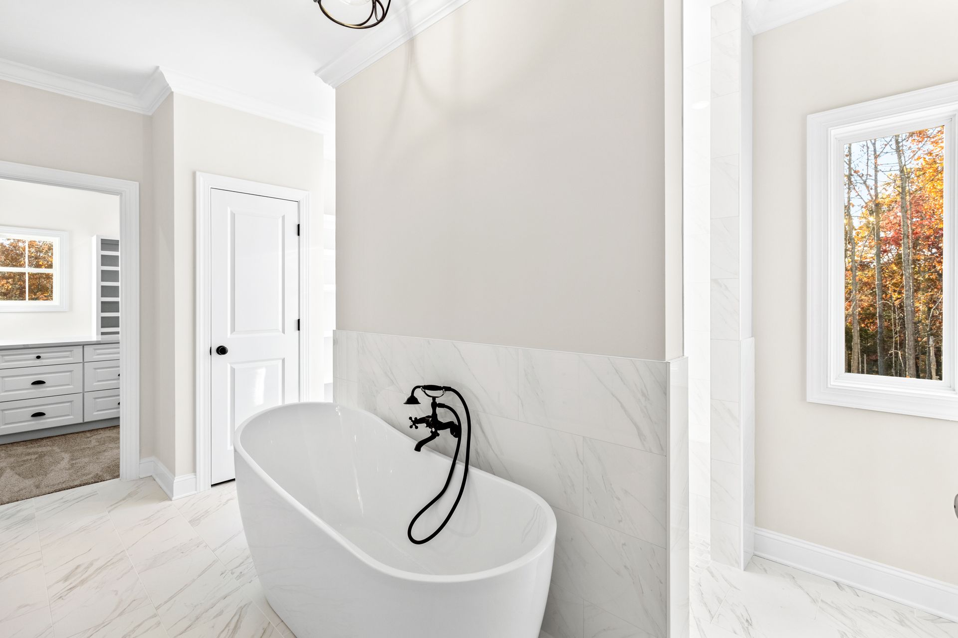 a bathroom with a bathtub and a window .