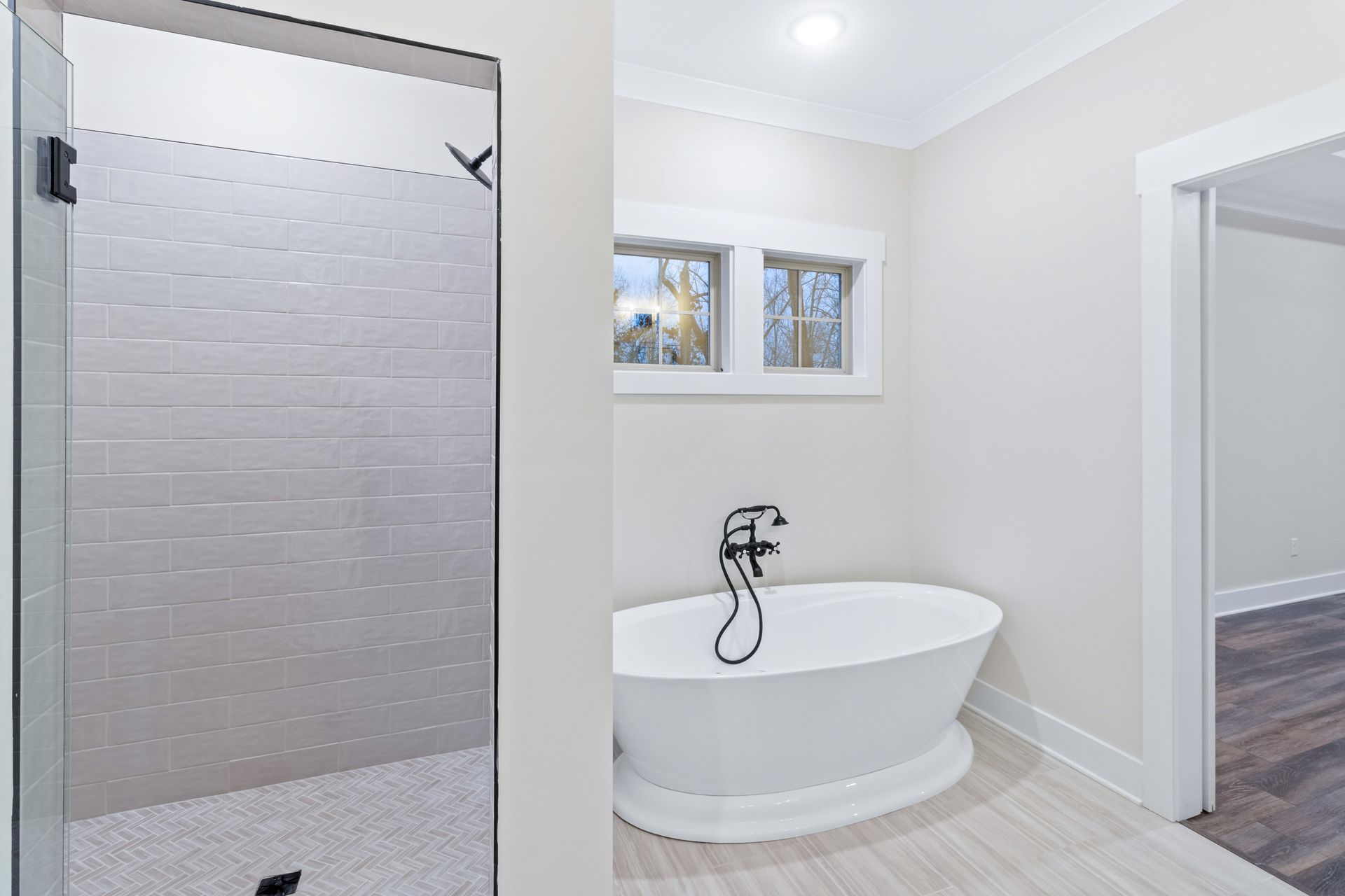 a bathroom with a tub and a walk in shower .