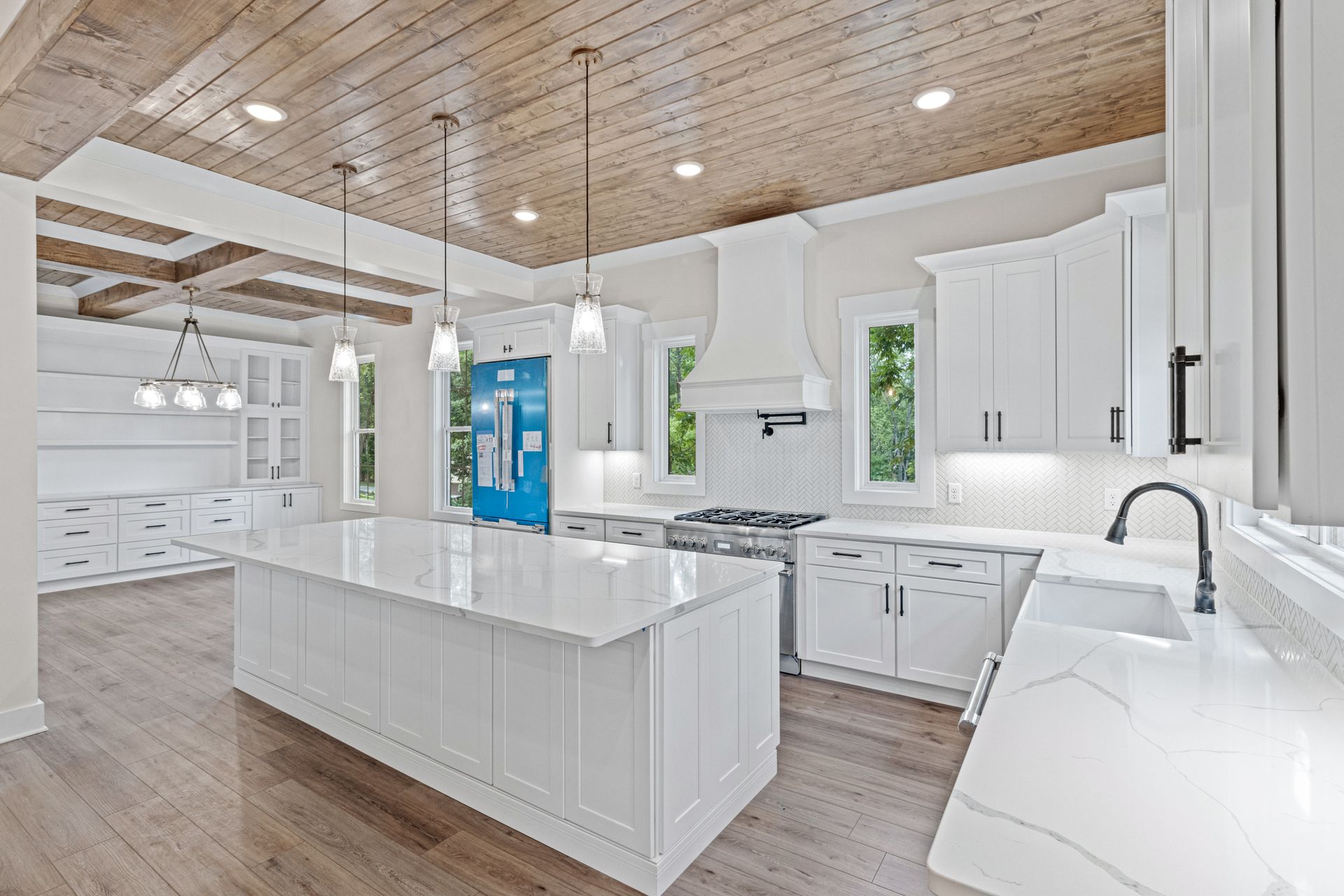 a kitchen with white cabinets and a blue door .