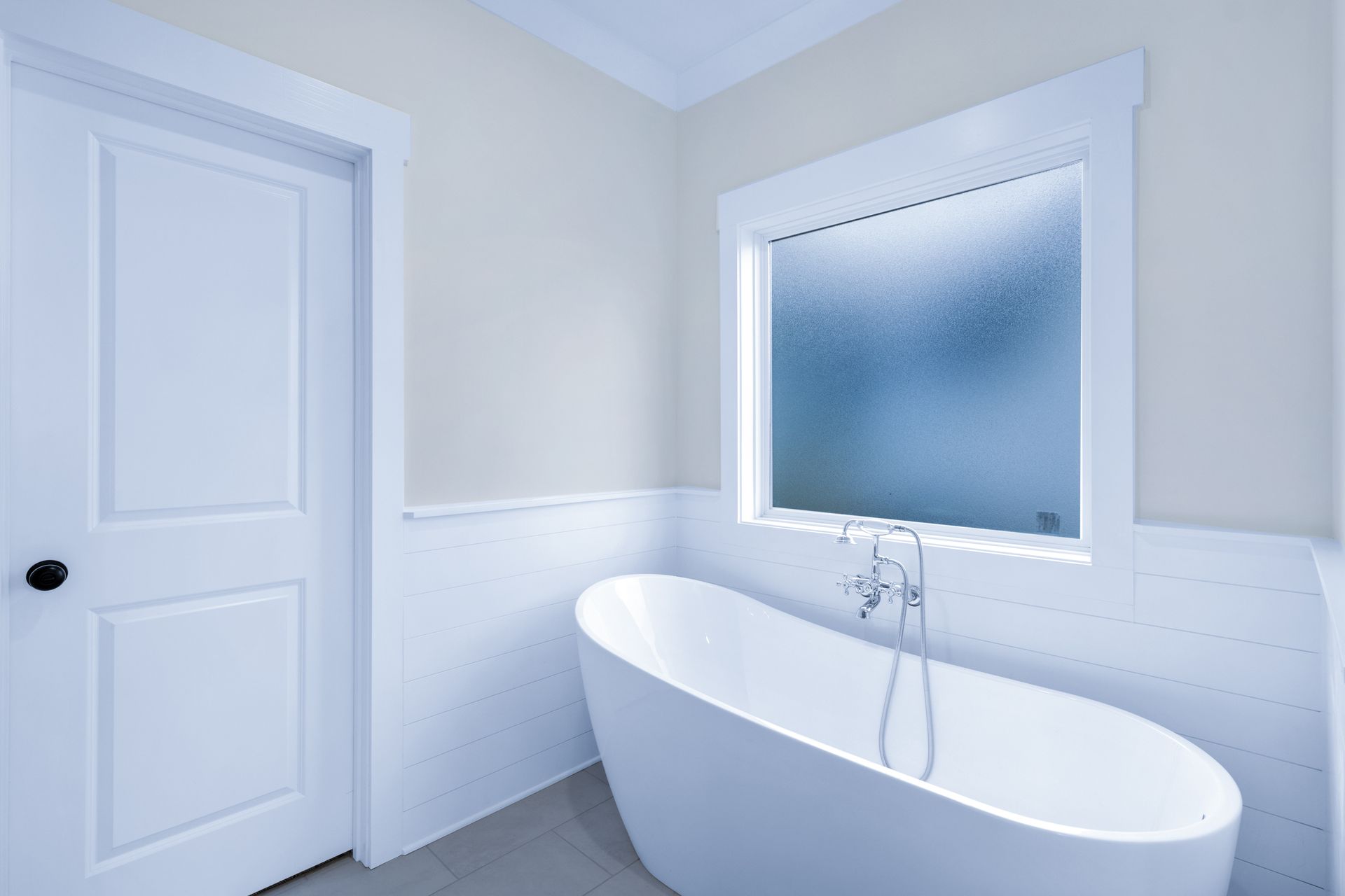 a bathroom with a bathtub and a window