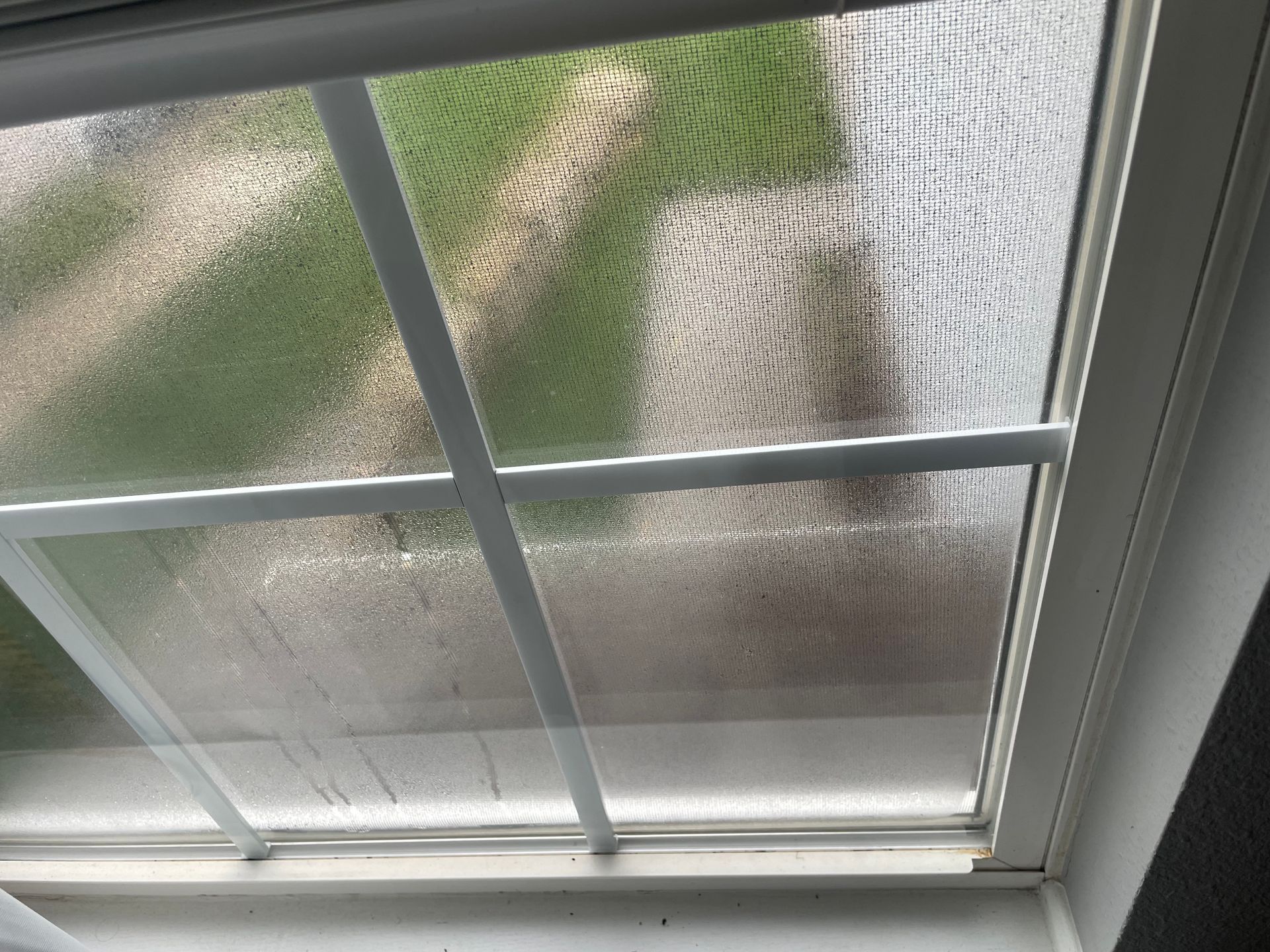 Fogged up window with condensation on the inside of the glass