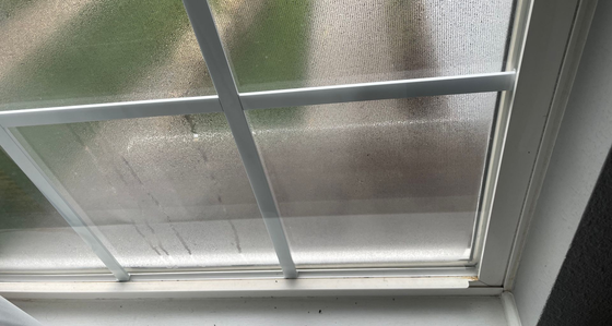 Fogged up window with condensation on the glass that needs replaced