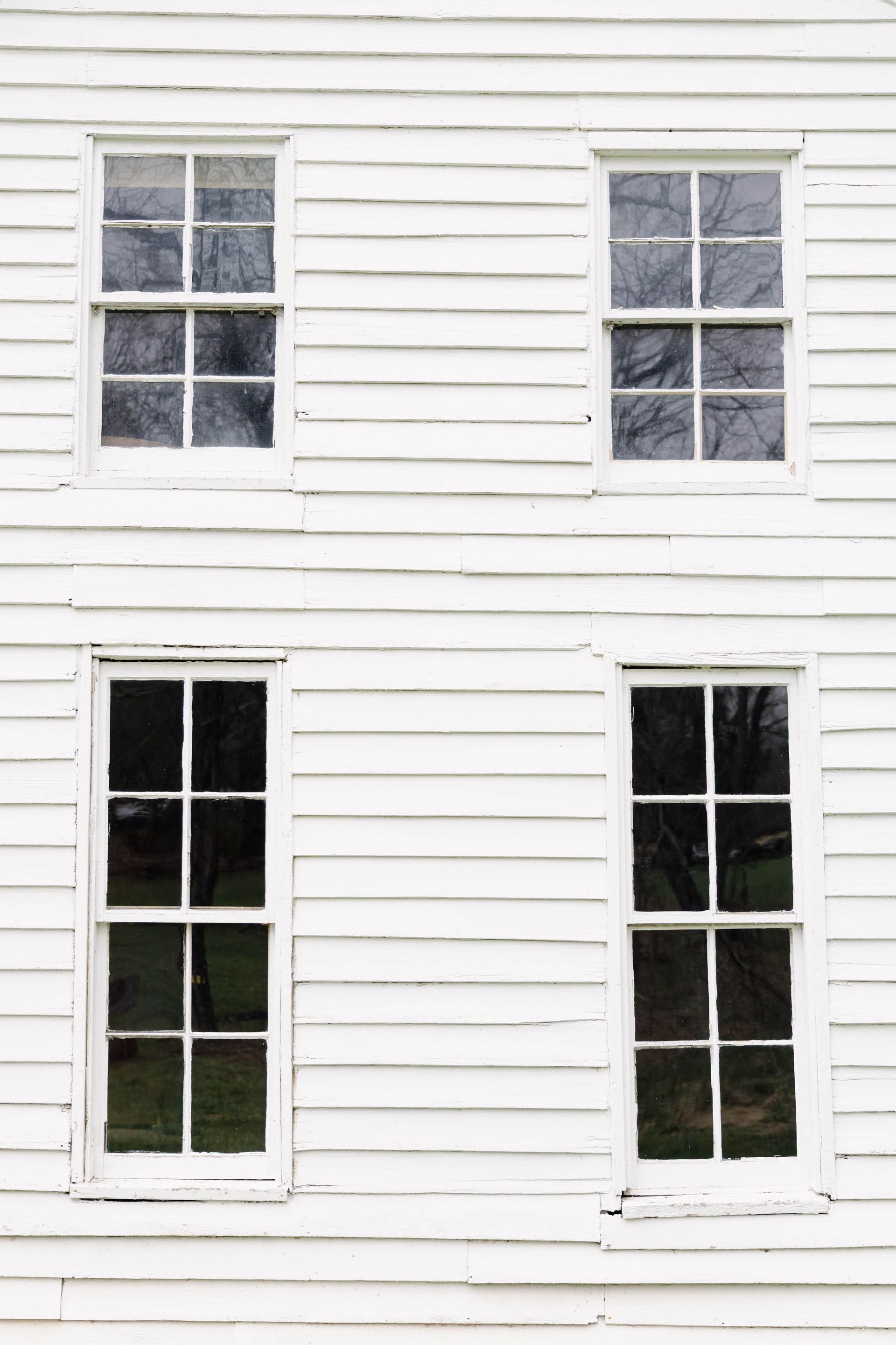 White clapboard house with older six-over-six double-hung windows