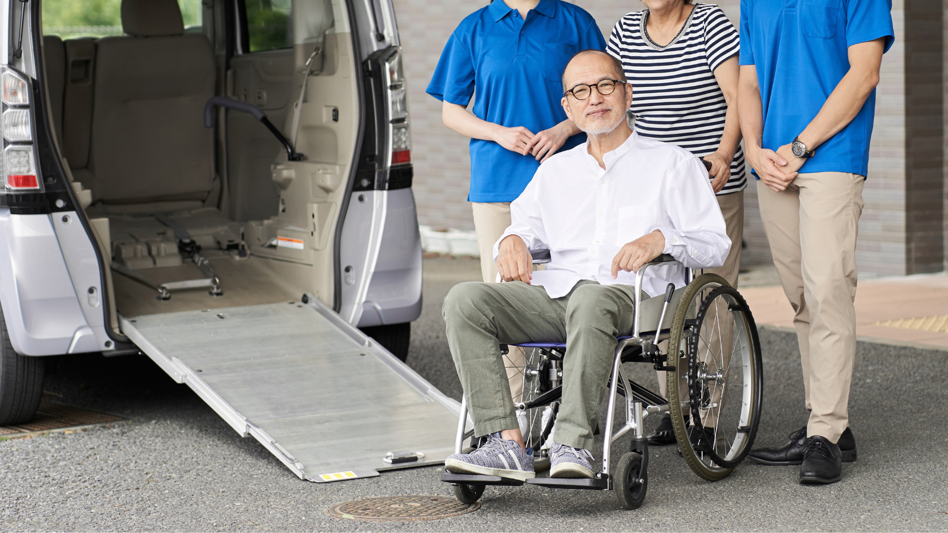 A man in a wheelchair is being pushed by a group of people.