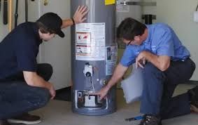 Comfort Air Solution LLC - A man is fixing an air conditioner with a screwdriver.