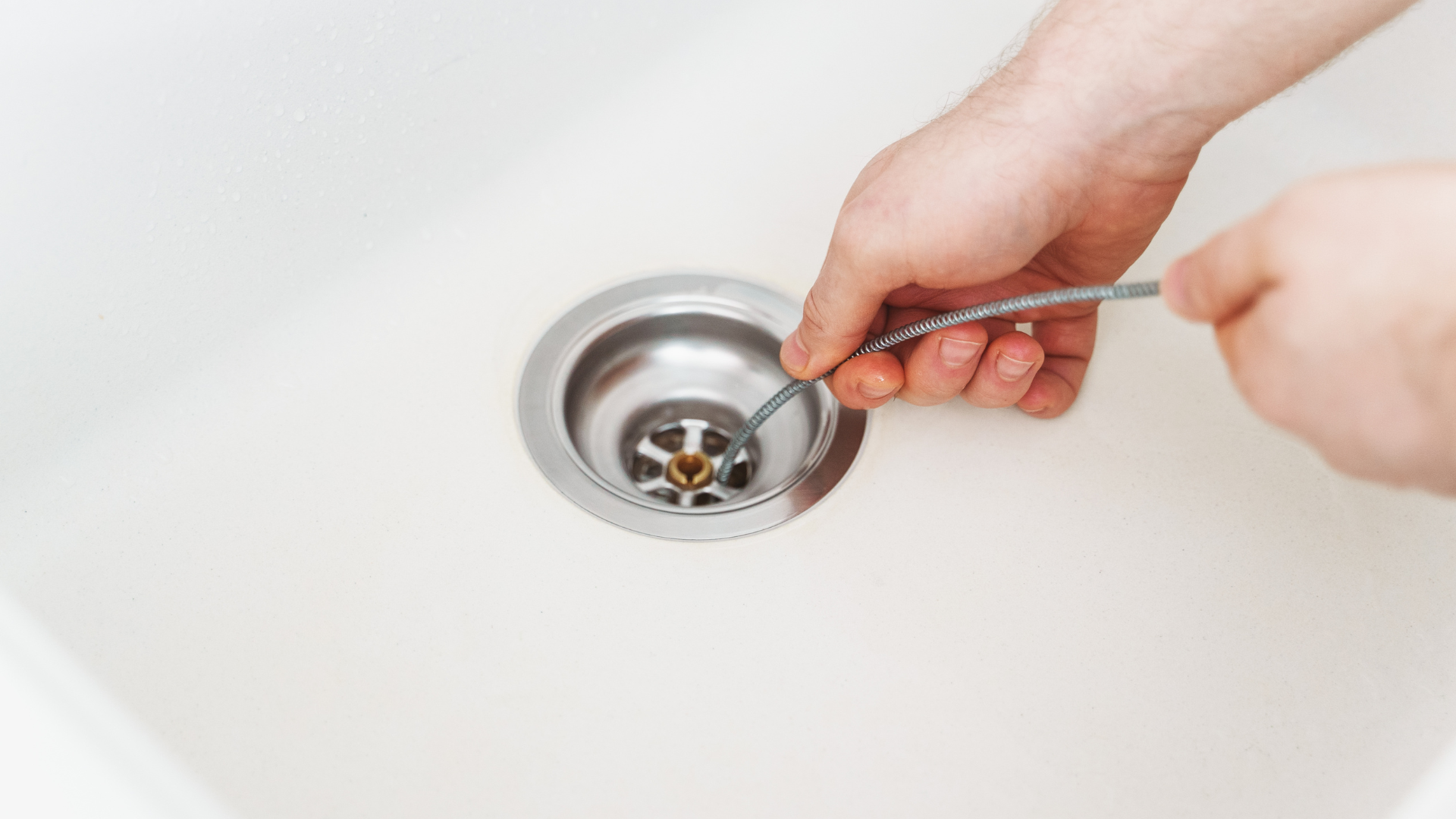 Comfort Air Solution LLC - A man is fixing an air conditioner with a screwdriver.